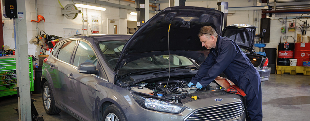 Mechanic servicing a car engine